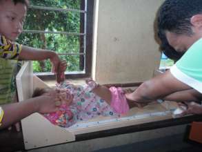 Baby screened for malnutrition at a health clinic