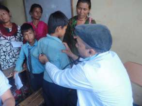 Doctor checks a boy's vital signs