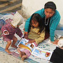 Children at an NRH reading a book