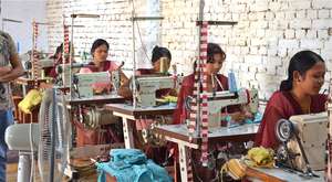 Former Kamlari at sewing class