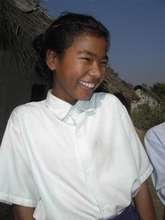 A happy young girl attending school.