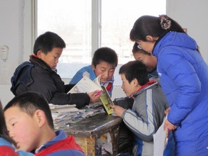 Fifth graders discussing a book in class.