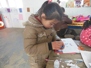 A student concentrates on her blueprint.