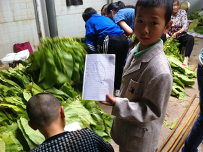 A student shows off his drawing.