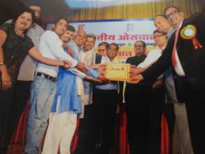 Receiving award from Akhil Bhartiya Oswal Parishad