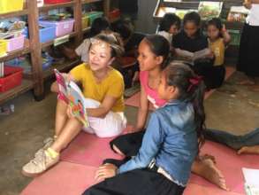 Volunteer Sarah reading with our students