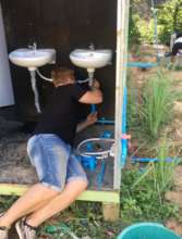 Volunteer Tom working on the plumbing!