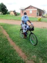 Mentor Mother in PPE visits clients in Uganda.