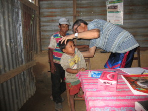 checking for ear infection on a young villager