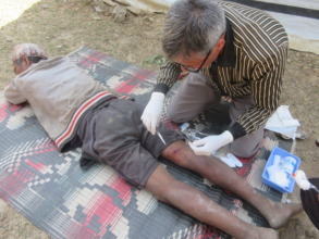 Bharat Surkheti being treated by clinical officer