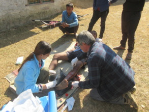 Clinical officer stitching wound of Suresh Gurung