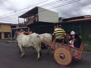 Riding the traditional oxcart around the community