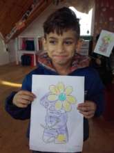 Marius showing off a picture he coloured