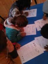 Younger children practising their writing