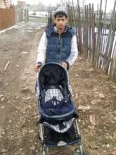 New Dad with buggy donated by Refugiu