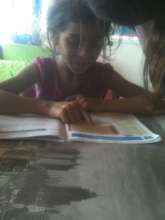 Gabriela reading with her big sister, Loredana
