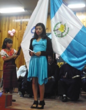 Yomara Floridalma receives her 6th grade diploma