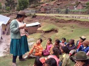 Ignacia presents to the children of her community