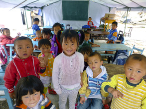 Young children gather in classroom