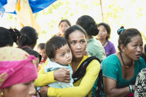 A woman listens to awareness on vital registration