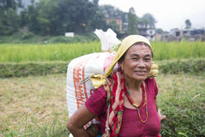 A woman carries supplies to her home in the camp.