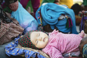 A baby sleeps in our Female Friendly Space.