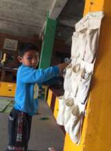 Kamal learns to put away the cards after a game.