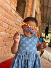 Maya wearing a mask she made as an art project.