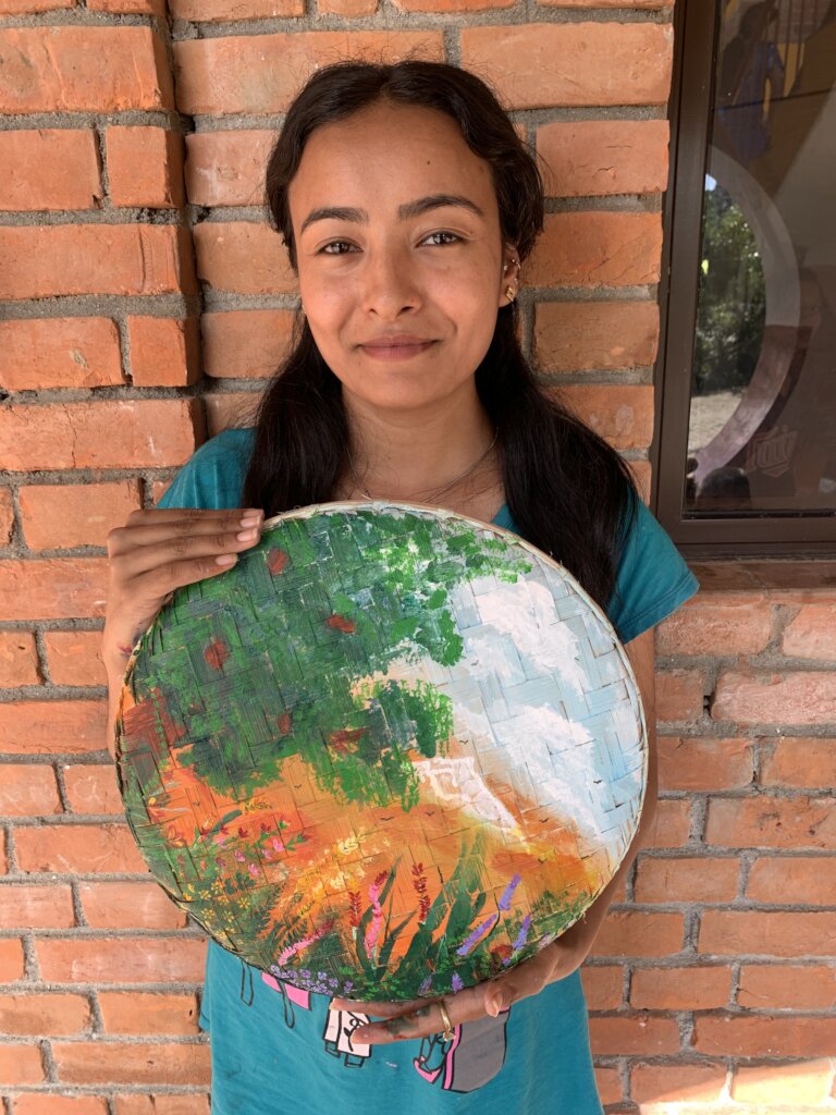 Sangita with artwork she donated to our auction