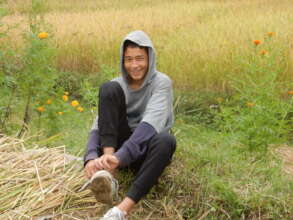 Akshar during Ama Ghar's rice harvest