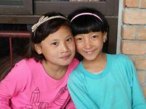 Maya (R) with her new sister Anjana (L).