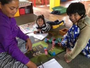 Ganga "studies" while her sister is tutored.