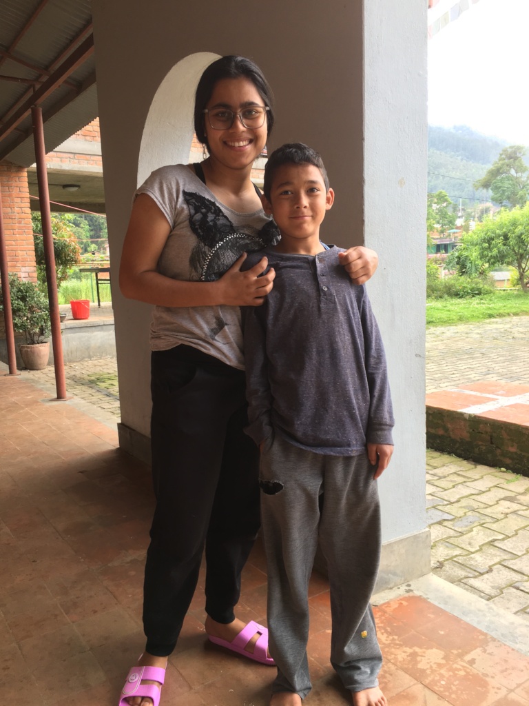 A young Akshar with Ama Ghar alum Jenuka