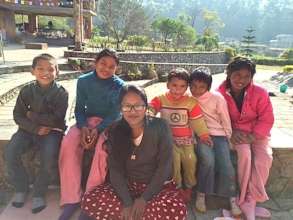 Rosina, second from left, arriving at Ama Ghar