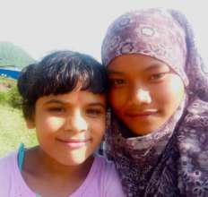 Rosina and her little sister Leela at rice harvest