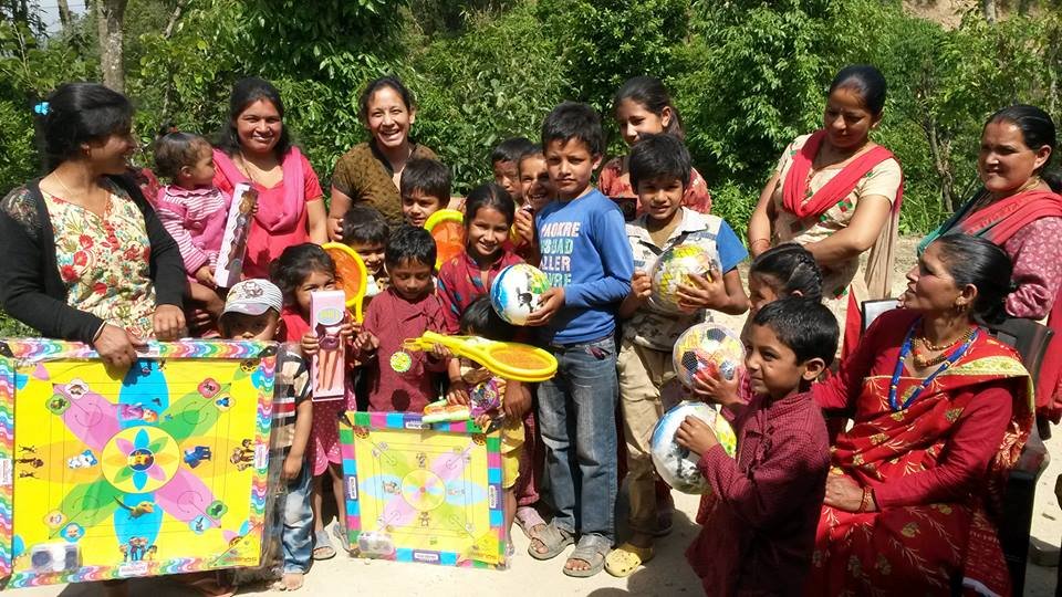 Giving play items to children in Lalitpur
