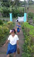 girls and boys haul water up hill together