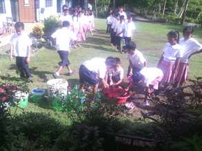 hand washing before lunch using pails and tubs