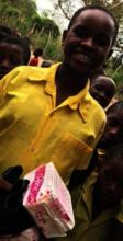 One of our beneficiaries with a pack of Nia pads!