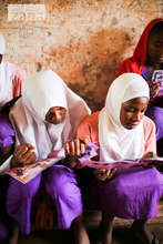 Girls Reading Nia Health Comics in Kwale