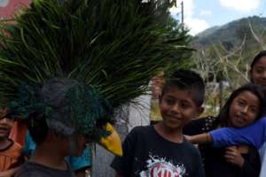 Children wear Quetzalo's mask