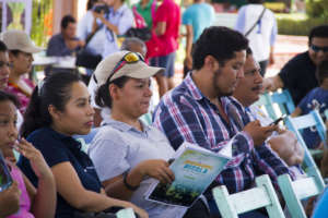 Audience members in the town square