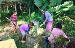 The children weed and pot plants in the garden