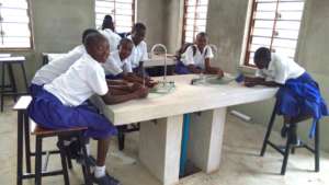 Students at lab bench with new faucets.