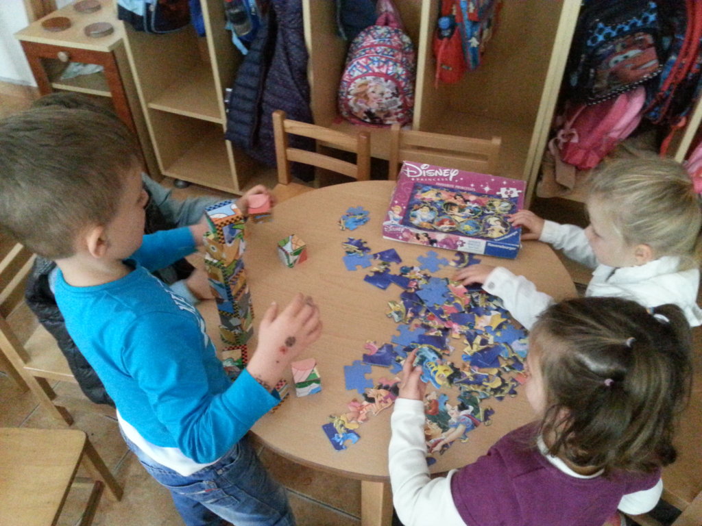 Children attempt a jigsaw puzzle