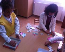 Girls complete the jigsaw puzzles