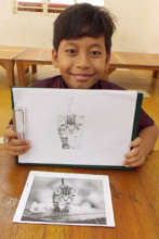 Student shows the drawing he is  now working on