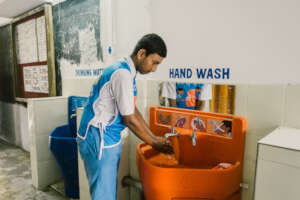 Student using a Splash handwashing station