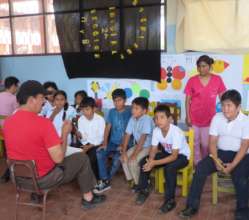 Aracely helping with instruction at a school