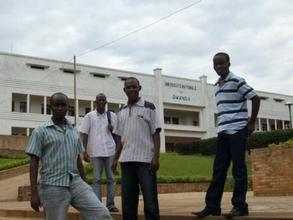 Four students in front of their university